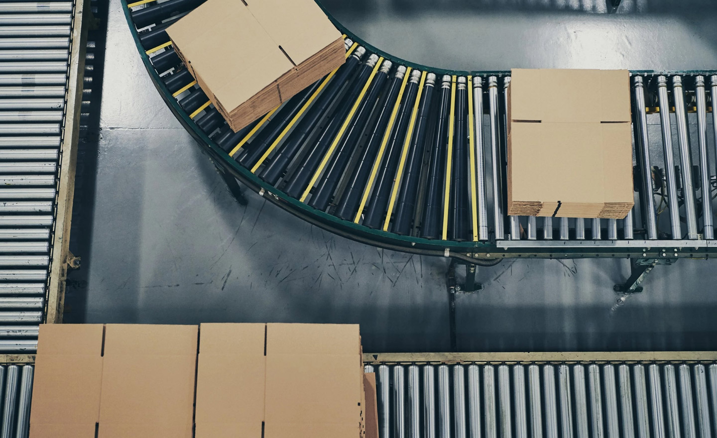 Production line with conveyor and cardboard boxes for industrial logistics and packaging